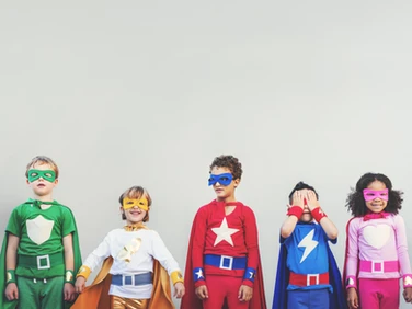 A group of children dressed up as superheroes.