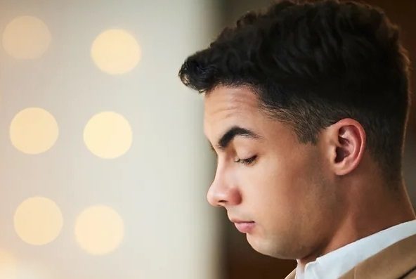 A boy wearing a formal cloth and crying