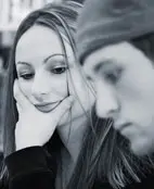 A black and white photo of a man and woman looking at each other.