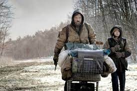 A man and a woman walking down a snowy path.