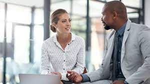 Two business people talking in an office.