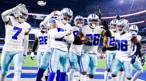 The dallas cowboys are celebrating on the field.
