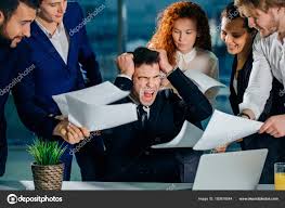 Man overwhelmed by paperwork and coworkers.